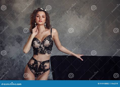 Attractive Fashion Model In Black Lingerie With Crown Stock Photo