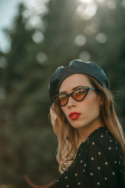 Premium Photo Young Woman In Vintage Black Polka Dot Dress Posing Outside