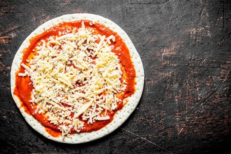 Premium Photo Preparation Pizza Rolled Out Round Dough With Tomato