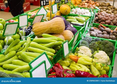 Various Fresh Fruits And Vegetables In Boxes On The Shelves Of The