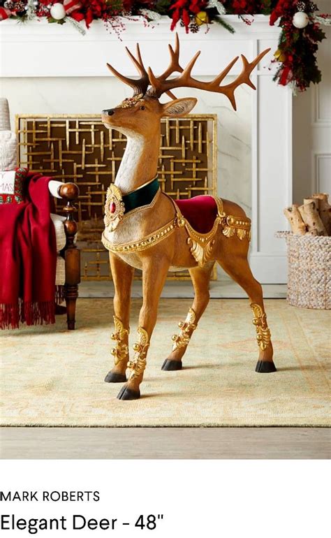 A Christmas Fireplace Mantel With A Deer Statue In Front Of It And