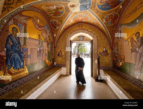 A Monk Walks Through The Entrance Of The Kykkos Monastery Which Is