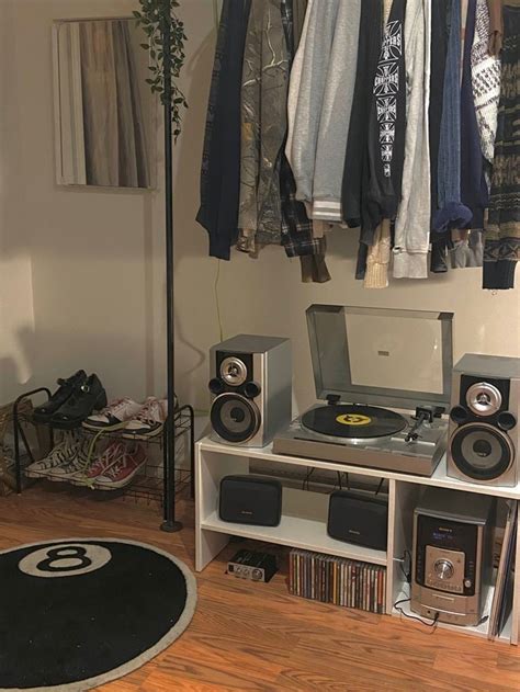 There Is A Record Player In The Corner Of This Room With Clothes