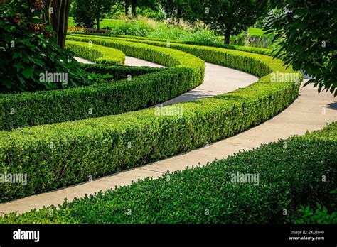 Concentric Circles Of Paved Walkway Separated With Hedges And Edged