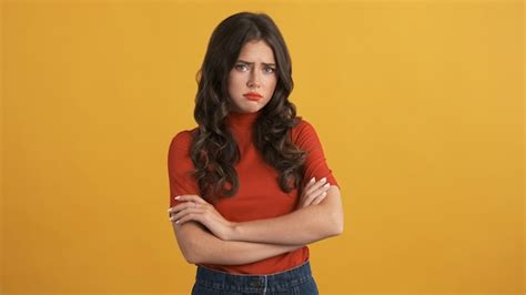 Free Photo Offended Upset Brunette Girl In Red Top With Hands Crossed