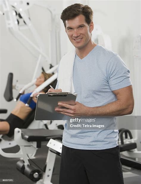 Male Personal Trainer Writing On Chart High Res Stock Photo Getty Images