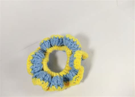 A Blue And Yellow Handmade Crochet Scrunchie Made Of Soft Yarn Stock