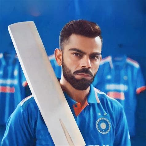 a man with a beard holding a cricket bat