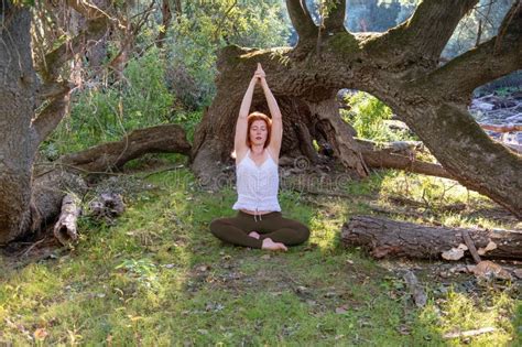 Young Redhead Woman Doing Asana Yoga Exercises Lotus Pose With Hands