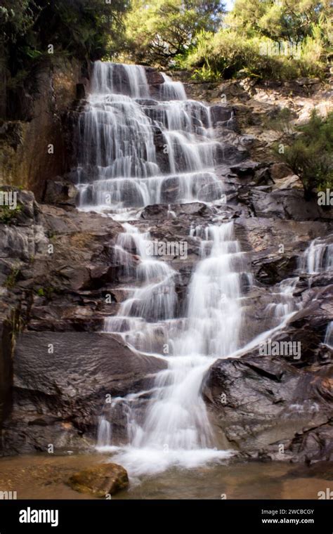 Waterfall Flowing Down A Steep Cliff In Cascades In A Stream In