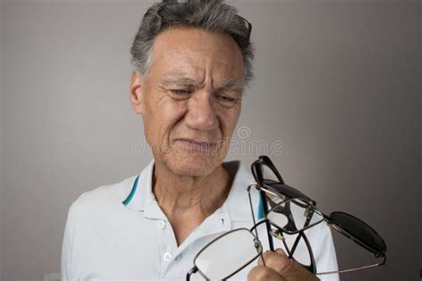 Mature Man Checking Out All His Old Eyeglasses Stock Image Image Of