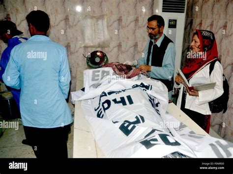 Paramedical Staffs Examining Dead Bodies Of Firing Incident Victims