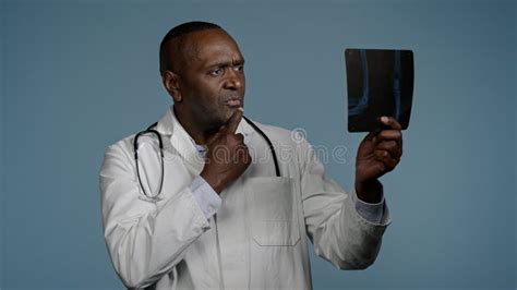 Mature Serious Man Radiologist Doctor Examining X Ray Check Results