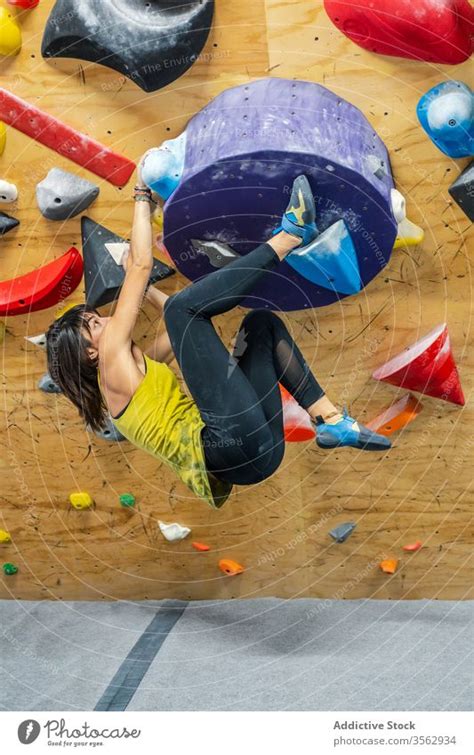 Powerful Female Boulderer Practicing On Wall A Royalty Free Stock