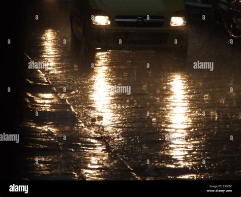 fast car driving in heavy rain at night in town Stock Photo - Alamy