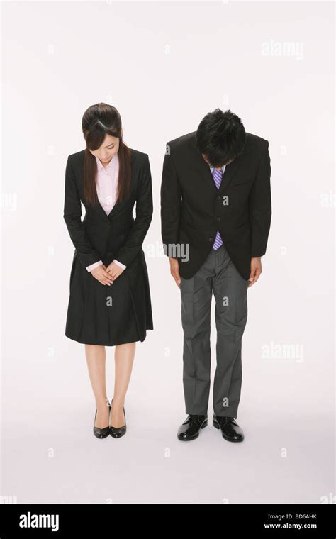 Businesspeople bowing down Stock Photo - Alamy