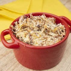 A Red Bowl Filled With Food Sitting On Top Of A Wooden Table Next To A