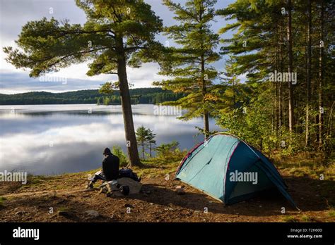 Hiker camping by Provoking Lake in Algonquin Provincial Park, Ontario, Canada, North America ...