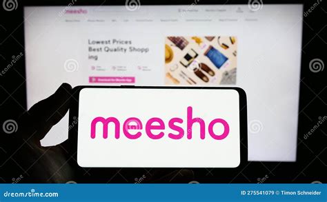 Person Holding Smartphone With Logo Of Indian E Commerce Company Meesho