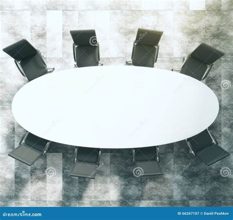 White Oval Conference Table With Black Leather Chairs On Concrete Floor