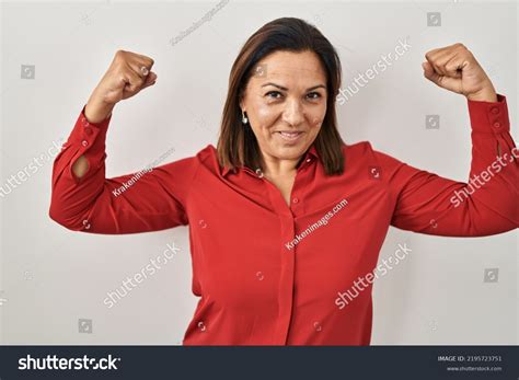 Hispanic Mature Woman Standing Over White Stock Photo