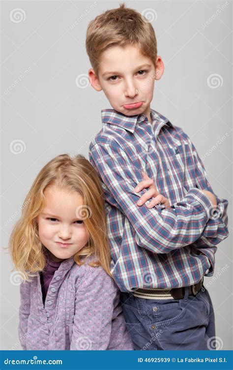 Angry Siblings Sitting Arms Crossed With Sad Mother On Sofa Royalty