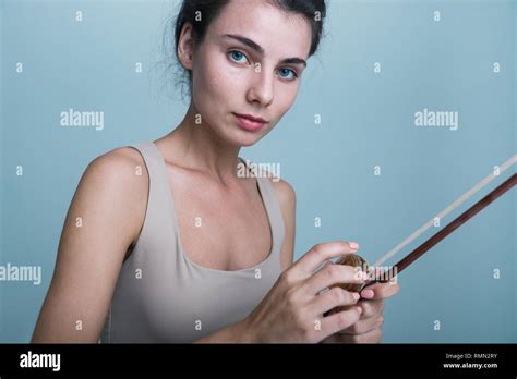 Close Up Portrait Of A Beautiful Young Woman Posing With A Violin