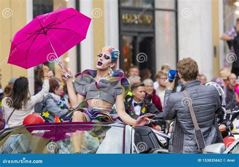 An Extravagant Drag Queen With A Pink Umbrella Attending The Gay Pride Parade Also Known As