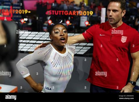 Gold medal winner Simone Biles of the U.S. and her coach Laurent Landi ...