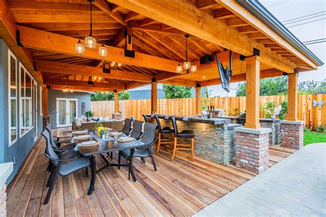 Stacked Stone Outdoor Kitchen And Bbq With Seating Area Rustic