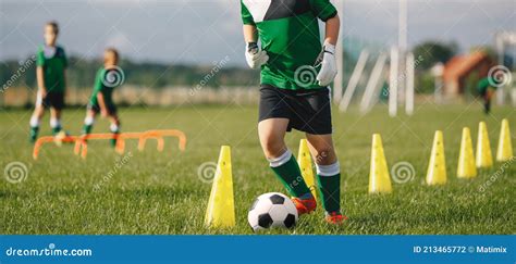 Kid Soccer Player Dribbling Through Cones Boy In Soccer Uniform