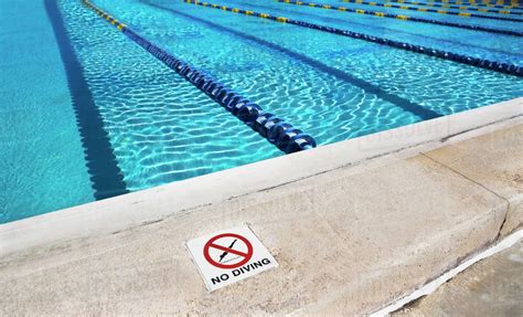 No Diving Sign On Edge Of Swimming Pool Stock Photo Dissolve