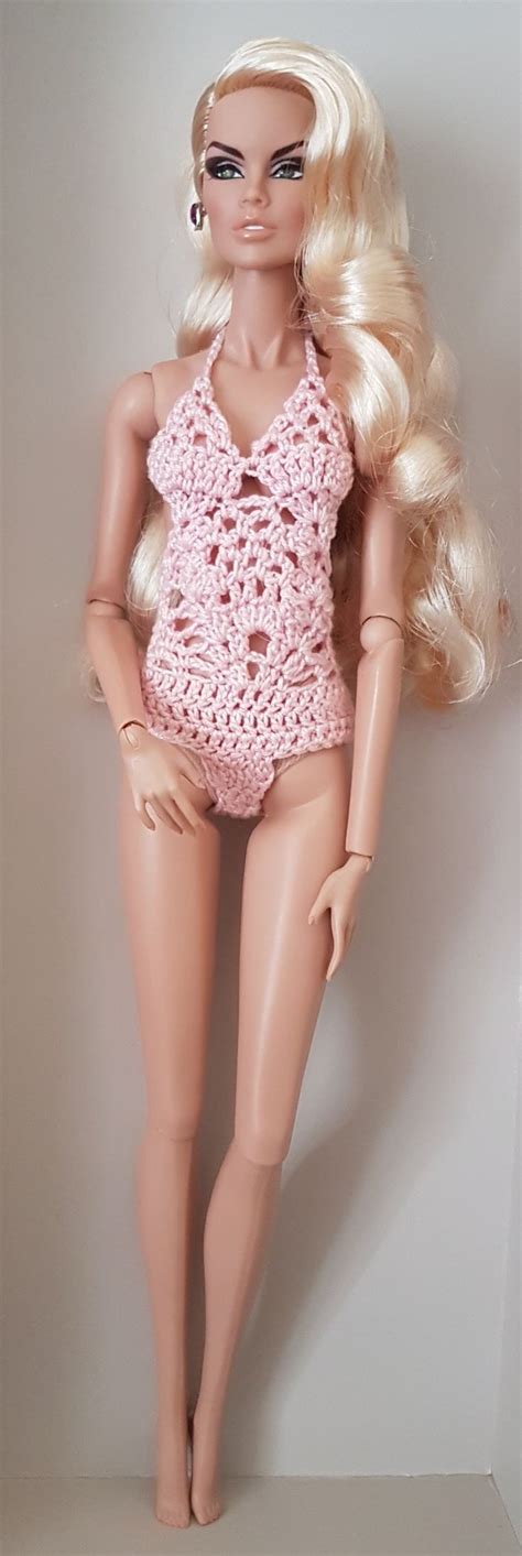 A Barbie Doll Wearing A Pink Crochet Swimsuit And Matching Hair Is