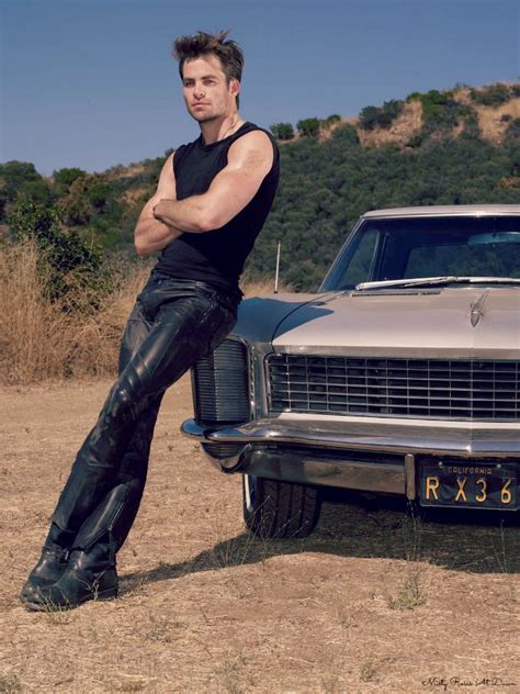 A Man Leaning On The Hood Of A Car