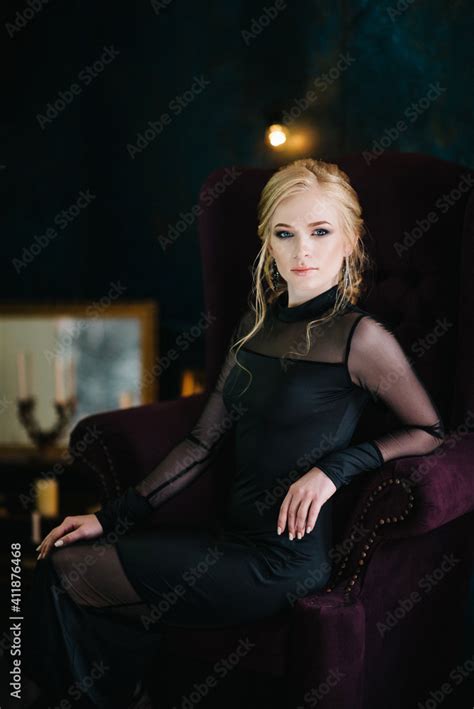 Blonde Girl With Blue Eyes In A Black Dress Stock Photo Adobe Stock