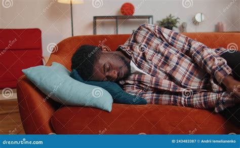 Exhausted Overworked African American Man Falling Asleep On Sofa After Party Tired Overworked