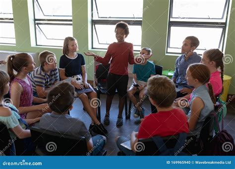 Group Of Elementary School Kids Sitting In A Circle Stock Photo Image