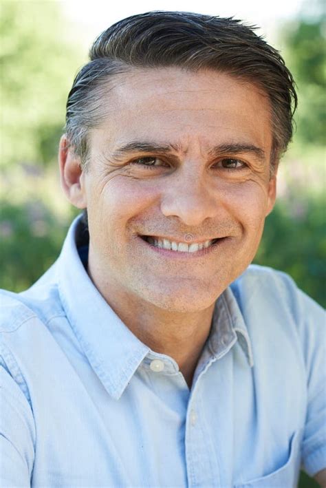 Outdoor Head And Shoulders Portrait Of Smiling Mature Man Stock Image