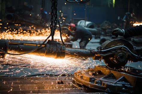 Industrial Worker Cutting And Welding Metal With Many Sharp Sparks