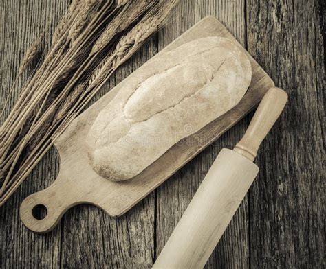 Fresh Bread With A Rolling Pin And Wheat On A Rustic Wood Stock Image