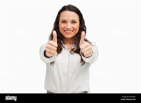 Portrait Of A Brunette Smiling While Approving Against White Background