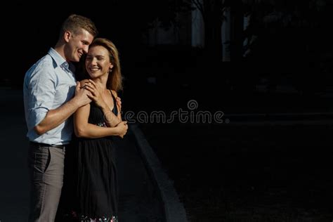 Happy Loving Couple Hugging Guy Kisses A Girl And Hugs From Behind