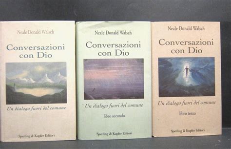 Three Books On Conversational Con Dio Are Lined Up Against A Black