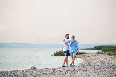 Rear View Of Senior Father And Mature Son Walking By The Lake Copy Space Stock Image Image Of