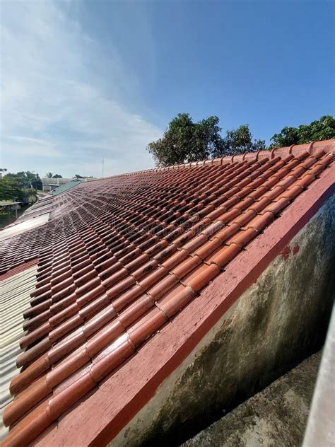 A Picture Of A House Roof That Is Starting To Blacken Is Taken From A