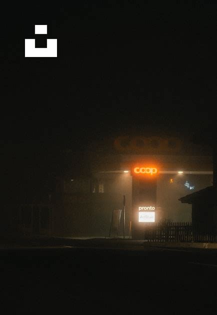 A gas station at night with a foggy sky photo – Free Coop Image on Unsplash