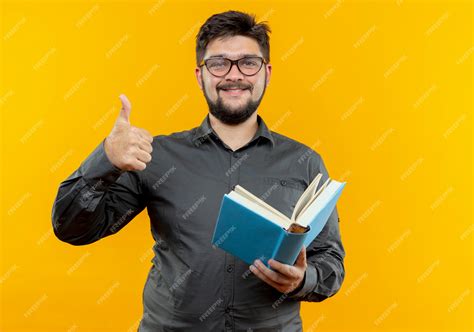 Free Photo Pleased Young Businessman Wearing Glasses Holding Book His