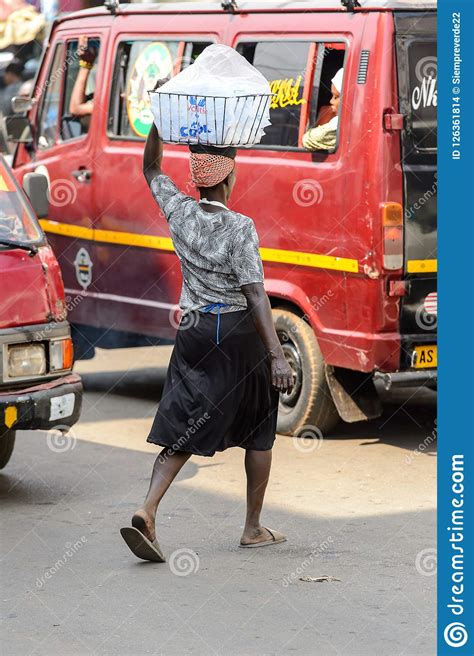 Unidentified Ghanaian Woman Carries A Basket On Her Head At The