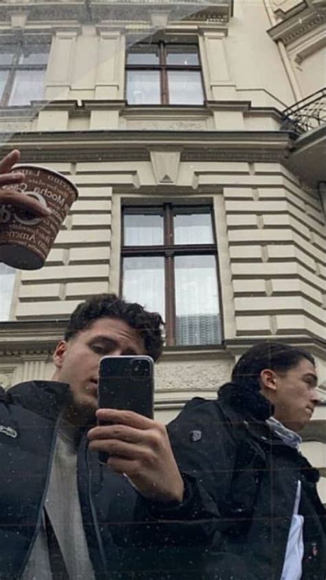 A Man Taking A Selfie In Front Of A Building