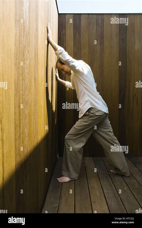 Man Leaning Against Wall Arms Raised Side View Stock Photo Alamy